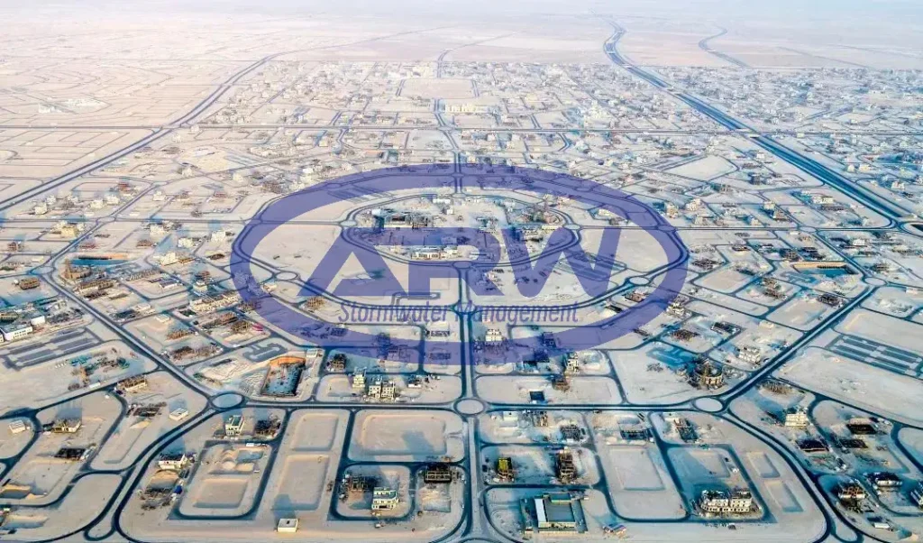 Aerial view of a Middle East desert city in early development—road grid and plots served by underground stormwater infrastructure.