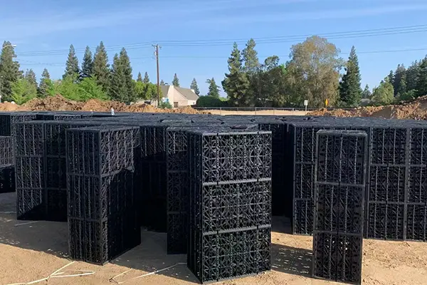 Wrapping modular infiltration tanks with non-woven geotextile fabric