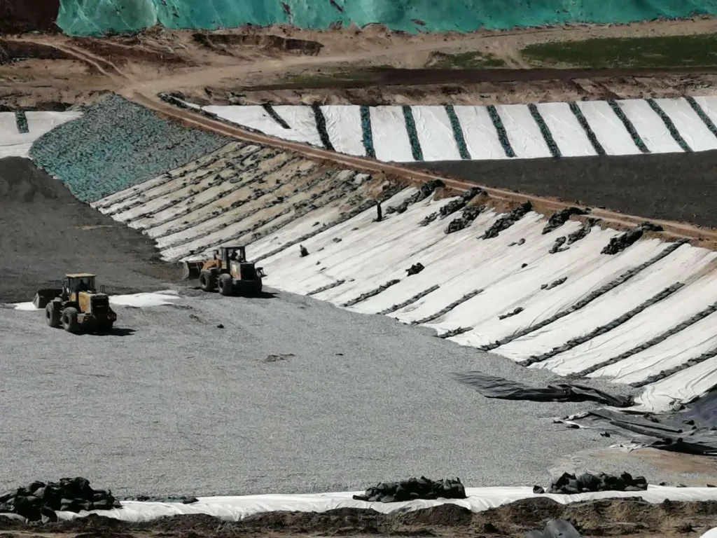 HDPE geomembrane liner installation for mining heap leach pad containment and solution collection