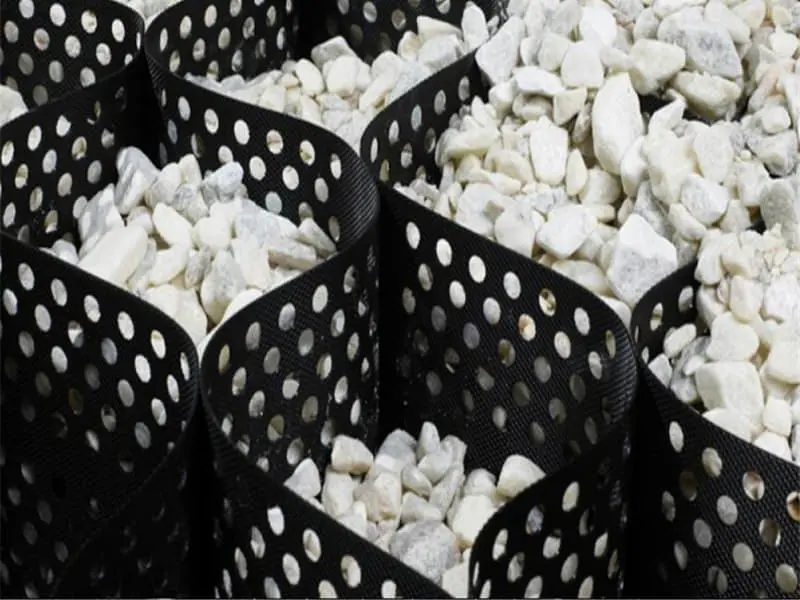 Geocellular confinement system for road base reinforcement and load distribution under heavy traffic