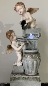 Classical cherub statue fountain on pedestal with small basins