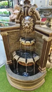 Large outdoor stone fountain with intricate carving details
